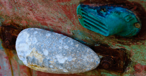 A metal object attached to the hull of a boat, is used as sacrificial anode to prevent electrolytic corrosion